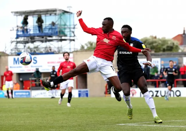 Morecambe's Carlos Mendes Gomes (left) and Tranmere's Emmanuel Monthe battle for the ball