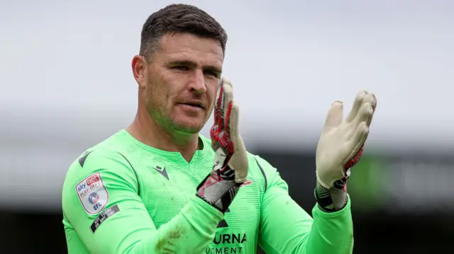 Morecambe keeper Kyle Letheren applauds