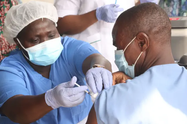 A person receives a dose of Covid-19 vaccine