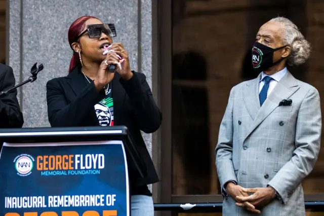 George Floyd's sister Bridgett Floyd (L) speaks, flanked by Rev. Al Sharpton, the founder and President of National Action Network, during a remembrance for George Floyd in Minneapolis, Minnesota, on May 23, 2021