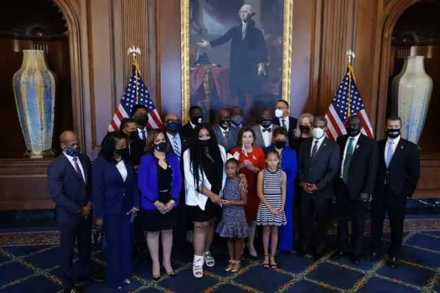 The Floyd family meets with Congresswoman Nancy Pelosi beneath a portrait of President George Washington