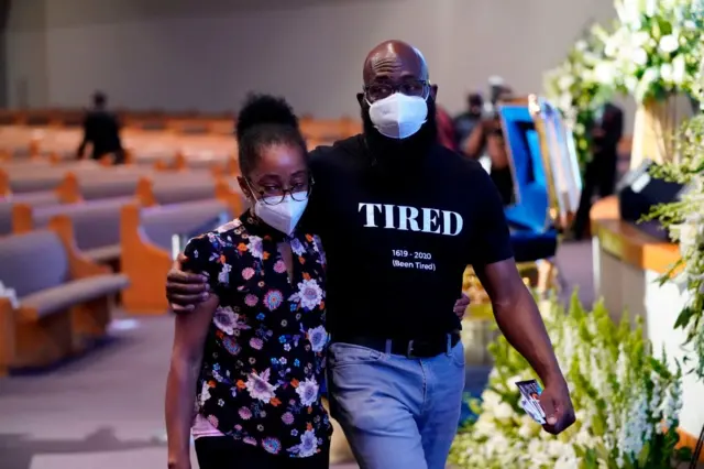 A mourner at Floyd's funeral wears a shirt saying "tired"