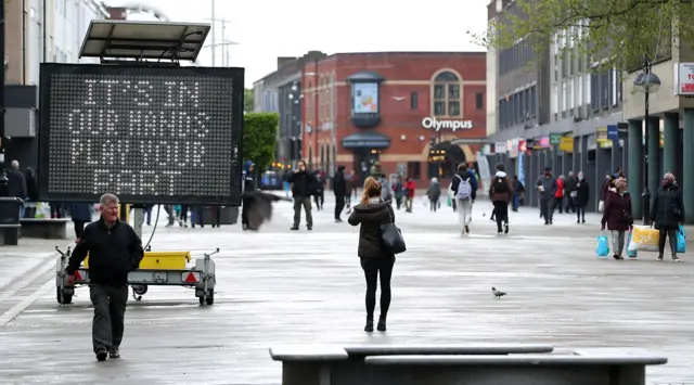 An electionic sign in Bolton saying 'it's in our hands, play your part'