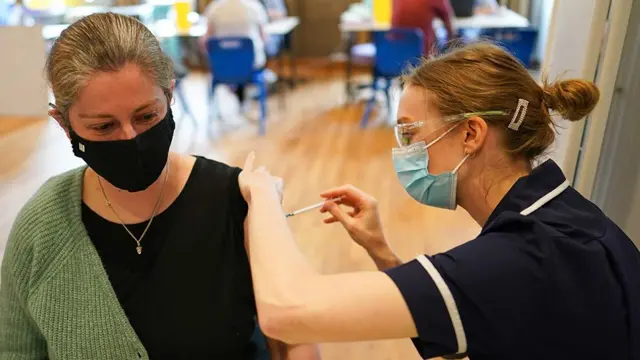 A woman being vaccinated