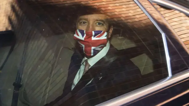 Matt Hancock wears a Union flag face mask in a car