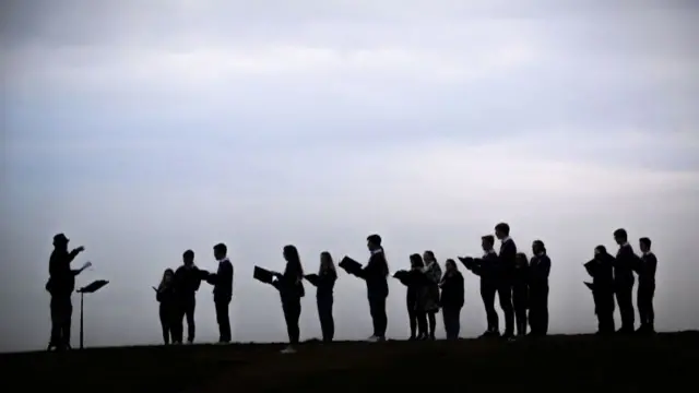 A choir rehearsing outdoors