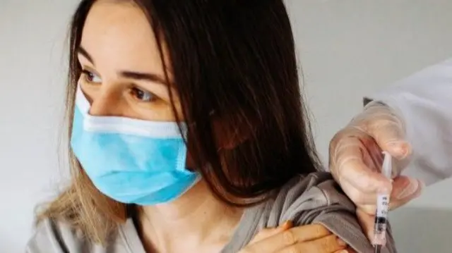 A young woman having a Covid vaccine