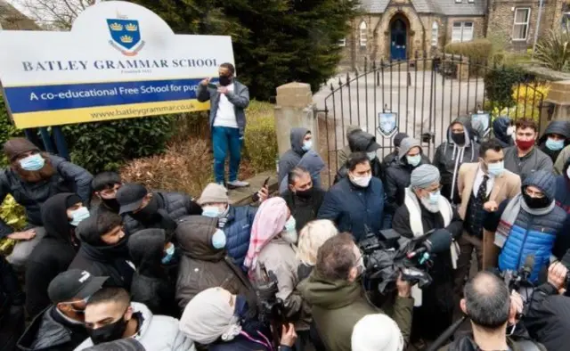 Protesters gathered outside the schoo