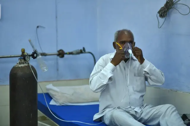 A man receiving oxygen in the outskirts of New Delhi, India