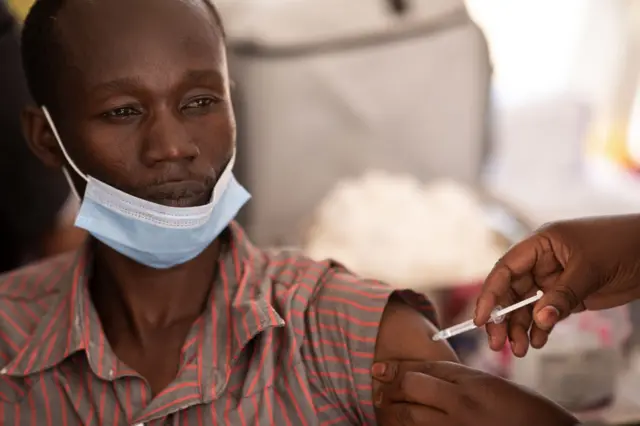 A health worker gets vaccinated in Kampala, Uganda