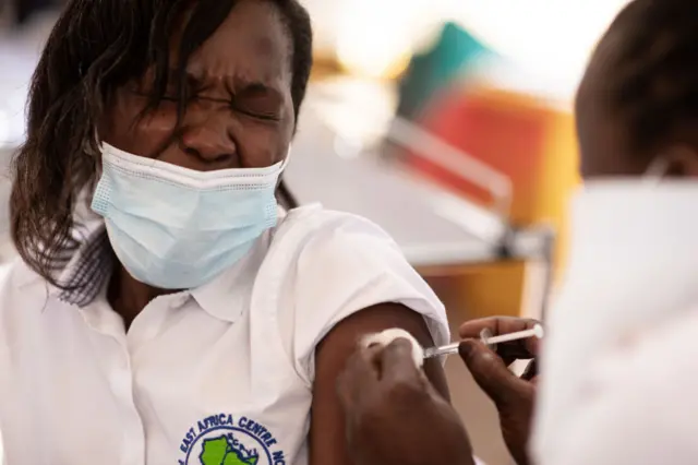 A health worker gets vaccinated in Kampala, Uganda