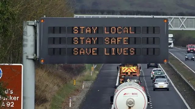 A sign tells people to stay at home