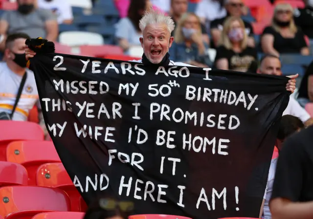 A Newport County fan holds up a flag