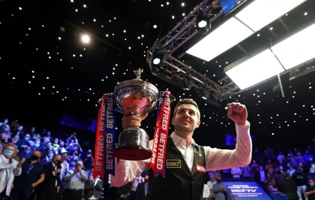 Mark Selby with trophy at Sheffield Crucible