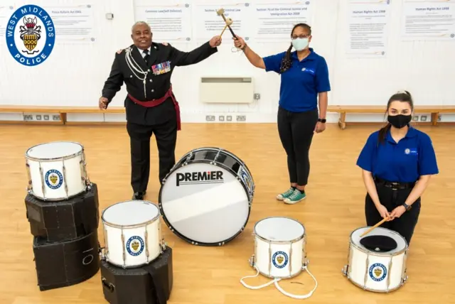 Barney Barnes, of WMP's brass band, with two cadets