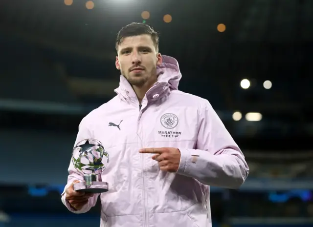 Ruben Dias with the man of the match trophy