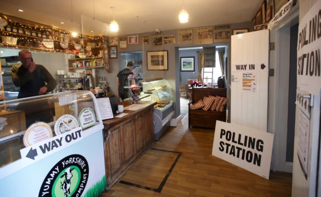 A polling station sign in a cafe