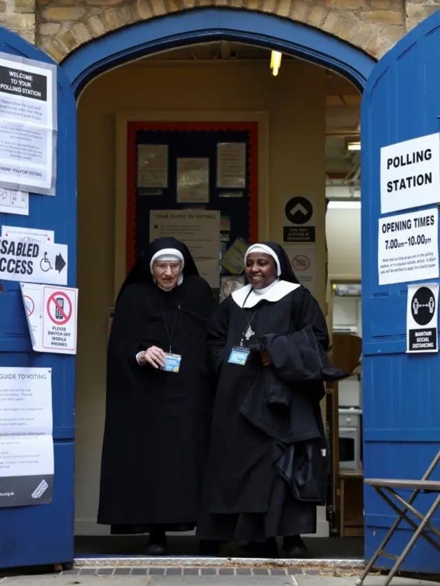 Nuns from the Tyburn Convent leave a polling station during local elections, in London.