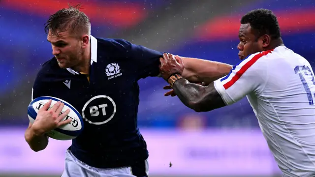 Scotland's Chris Harris hands off France's Virimi Vakatawa