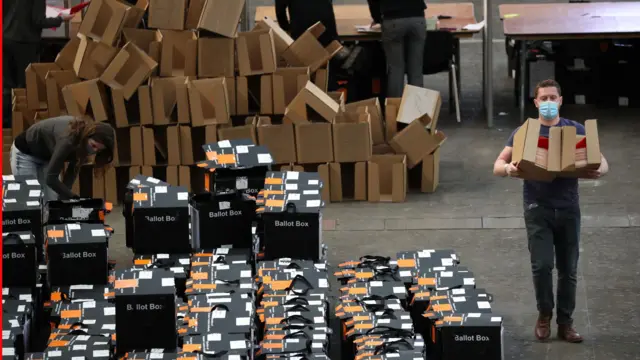 An election volunteer with a box of ballots during the counting for the local elections at Alexandra Palace