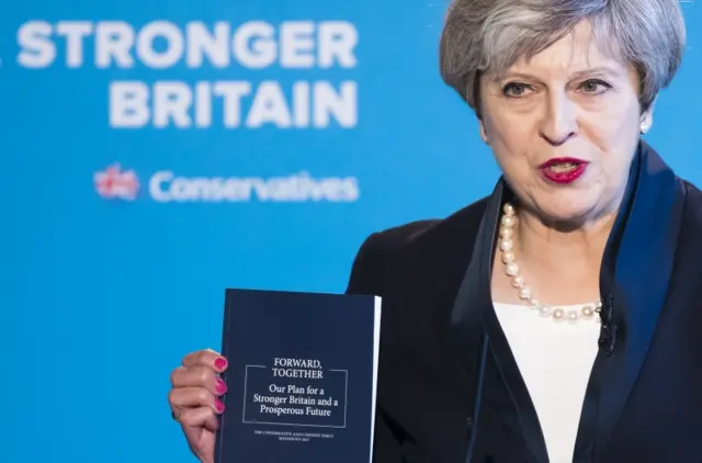 Theresa May holding Conservative 2019 manifesto