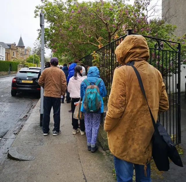 People queue to vote outside the polling station in Marchmont, Edinburgh