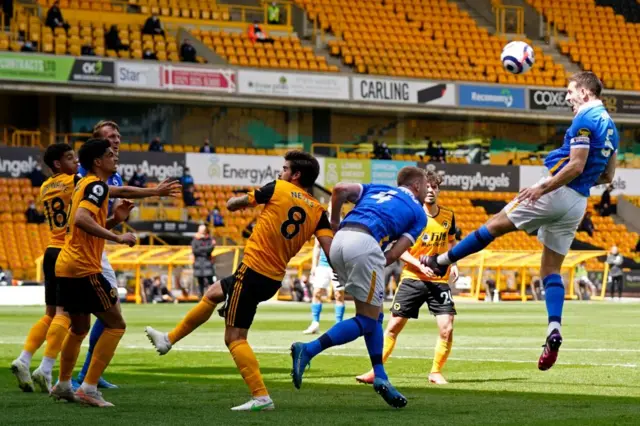 Lewis Dunk heads the ball for Brighton