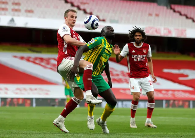 Arsenal's Rob Holding challenges