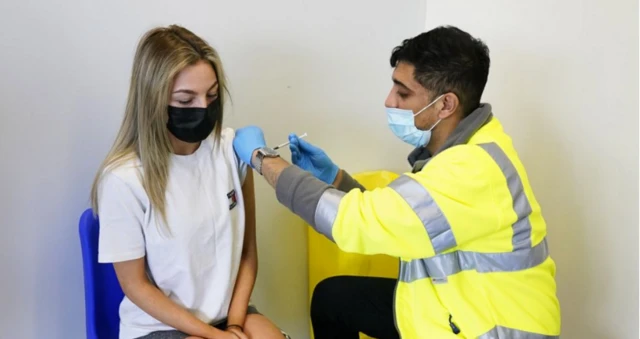 A woman getting the jab