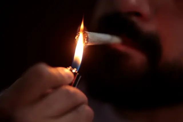 Cannabis joint being lit with lighter