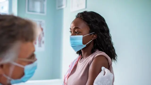 A young woman getting a Covid jab (file image)