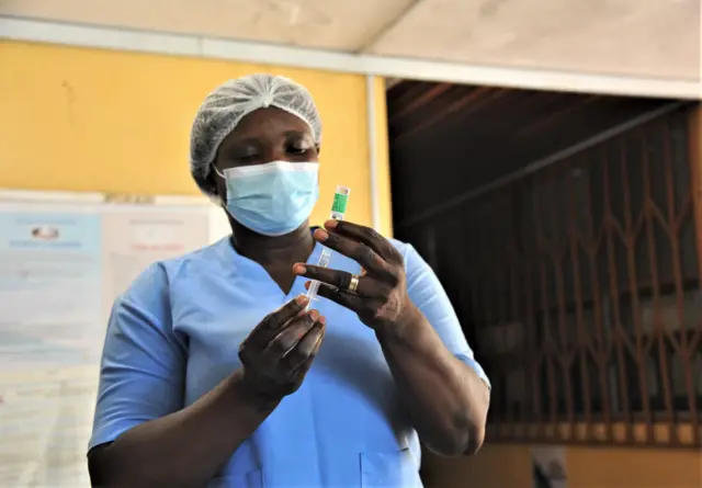 A medical worker prepares a dose of the Covid-19 vaccine at a hospital in Accra, capital of Ghana