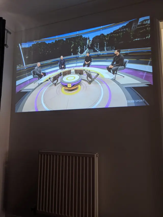 Fan watching BBC on projector