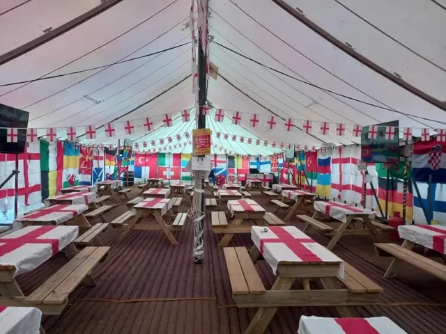 Inside the marquee with flags