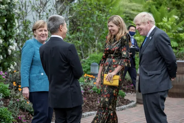 Chancellor Angela Merkel and her spouse Joachim Sauer, Prime Minister Boris Johnson with his wife Carrie Johnson attend a drinks reception at the Eden Project