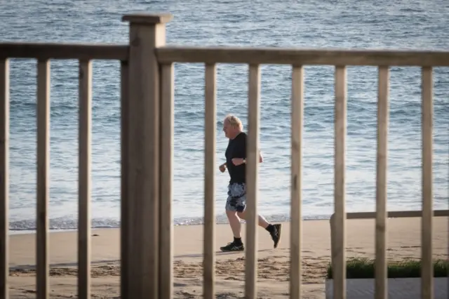 Boris Johnson runs along the beach in Carbis Bay