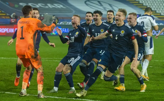 David Marshall is mobbed by team-mates after his decisive penalty save in Belgrade