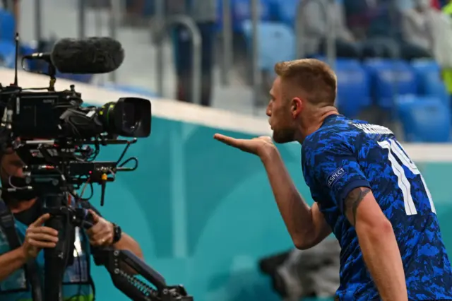 Milan Skriniar blowing a kiss into a TV camera after scoring