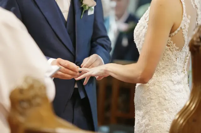 Close up of bride and groom's hands during wedding ceremony