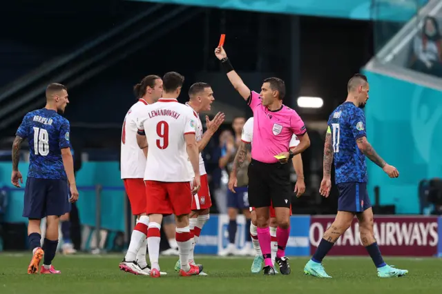 Grzegorz Krychowiak is shown the red card