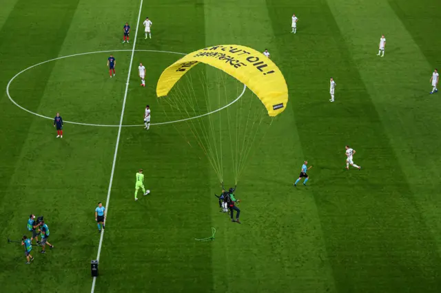 An activist landing on the pitch before kick-off