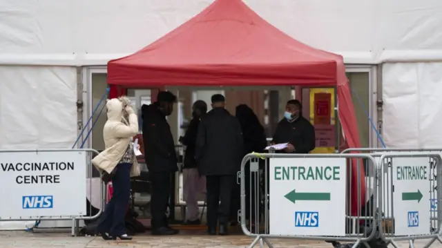 People queue at a vaccination centre in Blackburn