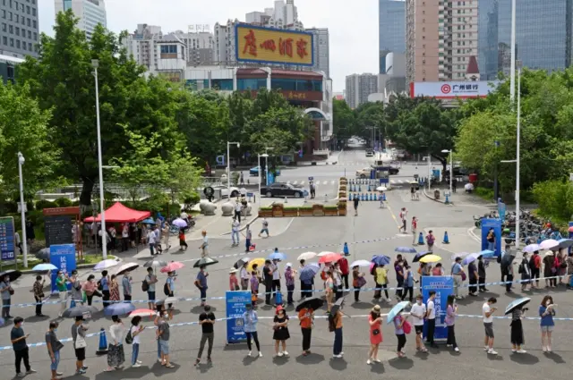 People line up to receive their vaccine outside a vaccination site in Guangzhou, Guangdong province, China, on 29 May 2021