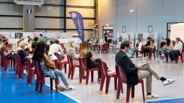 People wait to receive an injection of a Covid 19 vaccine at the temporary Covid-19 vaccination centre in a gymnasium in Saint-Maur-des-Fossés, outside Paris, on May 31, 2021