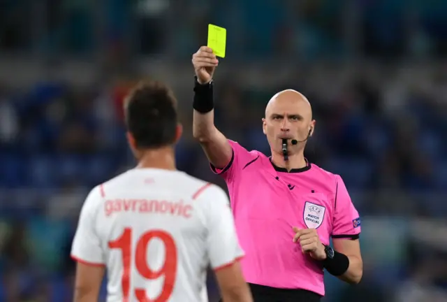 Referee showing a yellow card