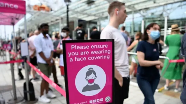 People queue up for the London Eye along the Southbank in London on 15 June