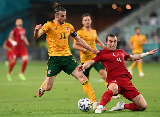 Gareth Bale tackled by Caglar Soyuncu