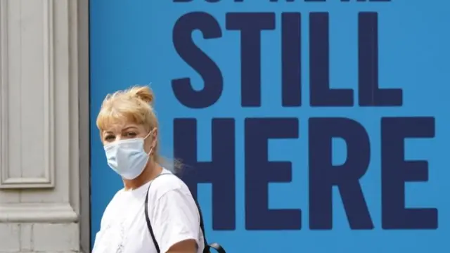 Woman in front of a sign