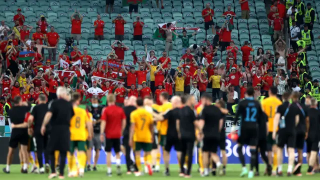 Wales' players go to their fans