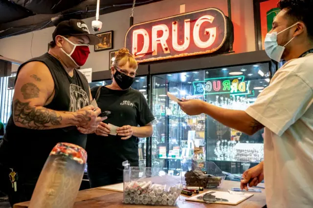 Mike Faris and Linda Meyers each select a free joint after attending the Joints4Jabs COVID-19 vaccination clinic, hosted by Pliable, at the Uncle Ikes White Center cannabis shop on 16 June 2021 in Seattle, Washington